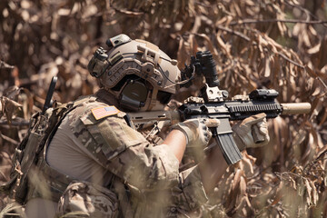 Special forces soldier in camouflage with a pair of weapons that are full of modern technology and complete for battle