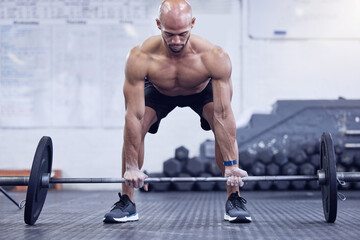 Male athlete, fitness and deadlift at the gym for muscles for a strong body for sport with motivation. Workout, barbell and man is training at a club for exercise with strength for weightlifting.