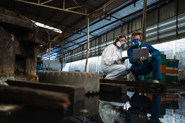 Chemical specialist working and inspecting chemical tanks in a factory. Inspection of chemical tanks in industrial plants.