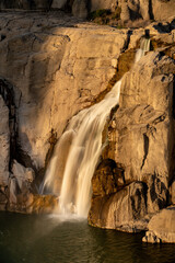 Small waterfall in the warm light of sunset