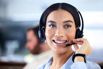 Customer service, woman with a headset and at her desk in a office at her workplace. Consultant or telemarketing, support or online communication and female call center agent smile at workstation