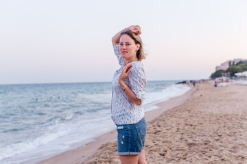 Portrait of a girl walking along the beach of the sea coast
