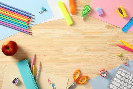 Back to school concept. Flat lay colorful school supplies on wooden desk table. Top view