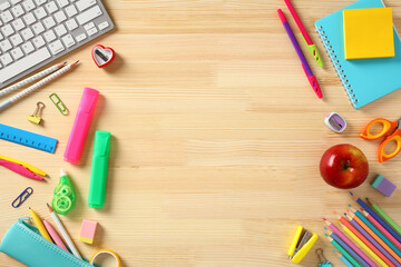 Back to school concept. Frame made of school supplies on wooden desk table.
