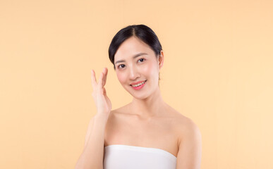 beauty asian young woman model with fresh glowing hydrated facial skin. girl person with natural makeup and healthy skin portrait isolated on beige studio background. spa treatment, skin care concept.