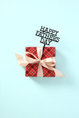 Gift box with message Happy Fathers Day on blue background. Happy Fathers Day concept