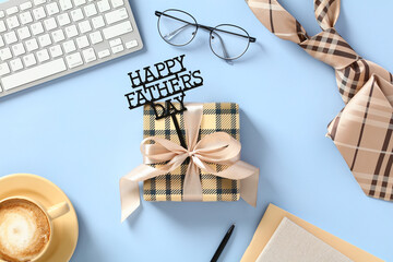 Happy Father's Day concept. Vintage gift box with message Happy Father's Day, glasses, tie, coffee cup, keyboard, paper notebooks on blue background.