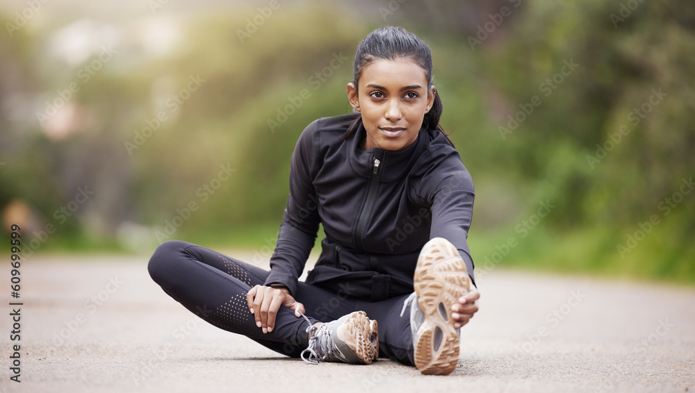 Wall mural Nature, warm up and woman stretching legs while sitting, workout motivation and fitness mindset with hands on feet. Focus, commitment and girl on floor, leg stretch for outdoor run and exercise goals