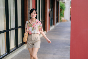 Portrait beautiful young asian woman on summer holiday vacation trip in Thailand. Young hipster female tourist sightseeing summer urban Bangkok destination. Asia summer tourism concept.