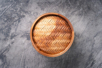 Chinese bamboo steamer on dark abstract background