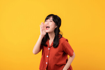 Portrait young beautiful asian woman happy smile dressed in orange clothes shout to free space...