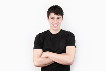 Fototapeta premium The young man is still a teenager with emotions of disgust, misunderstanding on face, does not know whether to be happy for him or cry. Emotions of an unpleasant surprise in a boy