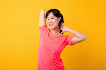 Portrait beautiful young asian sports fitness woman happy smile wearing pink sportswear posing exercise training workout isolated on yellow studio background. wellbeing and healthy lifestyle concept.