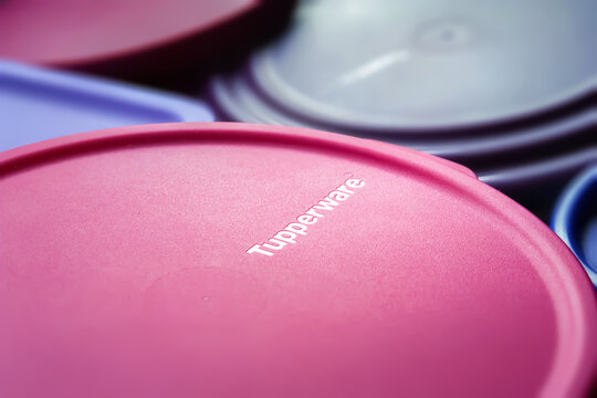 Tupperware lids with logo. Tupperware brand lids in full frame. Textured image with shallow depth of field. Ukraine. Kyiv. 06.02.2023