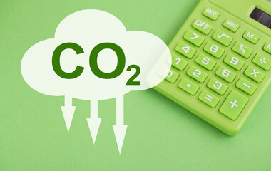 Tax CO2 calcurator. Decarbonisation. Sustainability. Green Calculator on green background. Green Clean Energy. 