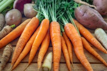 Set of various root vegetables on a wooden table