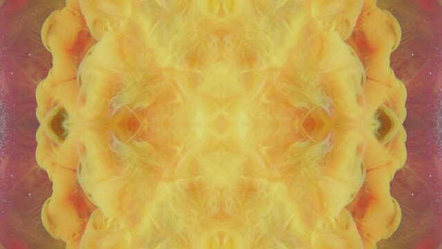 Paint splash. Kaleidoscope design. Ink water drop. Yellow red orange color smoke cloud explosion symmetrical pattern abstract background.