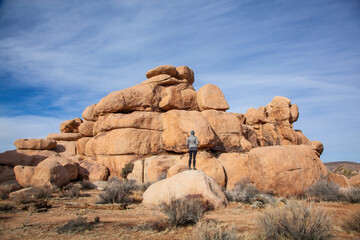 Woman admiring the giant rock formations of  Joshua Tree National Park