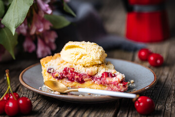 Tart with sour cherry creme, creme patisserie and crumbs, served with vanilla ice cream. Rustic and moody atmosphere and decoration. 