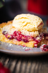 Tart with sour cherry creme, creme patisserie and crumbs, served with vanilla ice cream. Rustic and moody atmosphere and decoration. 