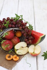 Fruits scattered from a basket, on a white table, vitamins, healthy food, background image