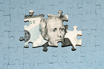 US dollar banknote under unfinished puzzle, bank crisis concept, US default, currency wars