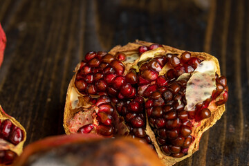 Rotten spoiled red ripe pomegranate on the board