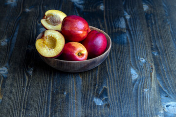Nectarines folded in a wooden bowl