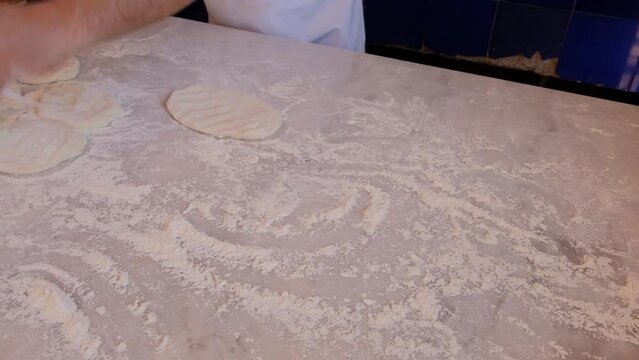 the preparation of the bread of Bafra style pide which is a Turkish pizza with meat