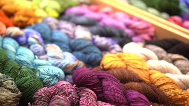 Yarn on a market, colourful wool closeup shot in 4K