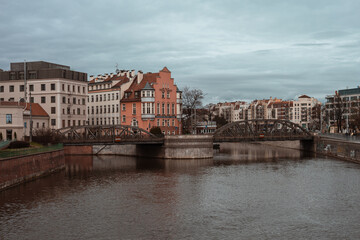 Fototapeta premium Most Mlynski, Wroclaw. Old buildings beyond the river