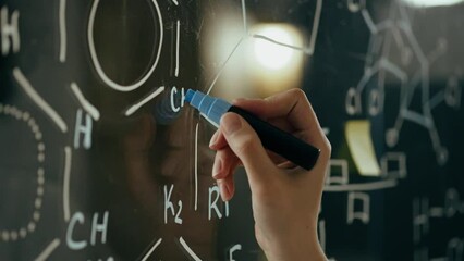 Explore, an experienced scientist writes on a glass board In the room for experiments. Time-lapse A specialist in the field of microbiology Is at the workplace Studying research data, write formulas
