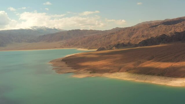 Ortho-Tokoy Reservoir, Kyrgyzstan. Stunning aerial view of lake surrounded by majestic sandstone mountains makes for picturesque landscape.