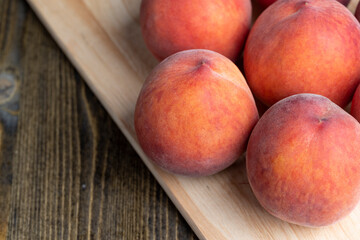 Ripe fresh peaches on a wooden table