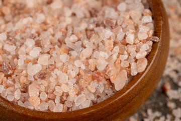 Pink natural salt on the table, close up