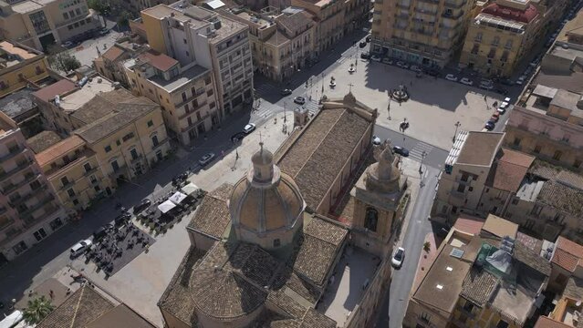 descending behind church dome in Gela Sicily