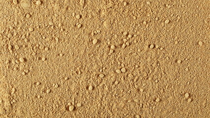 Ginger powder background and texture, top view 