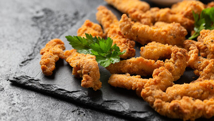 Crispy Shredded Chicken with sweet chilli sauce served on black slate. Party finger food snack concept