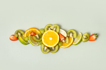 Citrus fruits and strawberries flat lay, top view. Summer layout on colored background