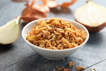Crispy Fried onions flakes in white bowl.
