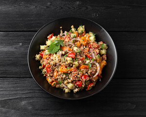 Red and white quinoa tabbouleh salad with tomatoes, paprika and mint. Vegetarian, vegan food concept