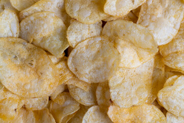 thin potato chips with spices, close up