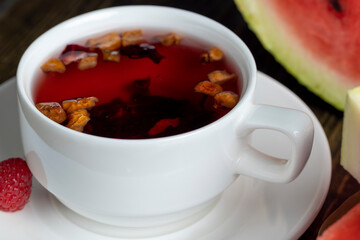 Red raspberry tea with pieces of fruit and berries