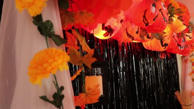 Scary party halloween decoration. Pumpkin buckets, skulls, tisue paper, maple leaves, lights, quinque, and cempasuchitl (marigold) flowers. Tilt.