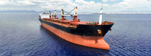 Aerial drone ultra wide panoramic photo with copy space of huge industrial bulk carrier tanker...