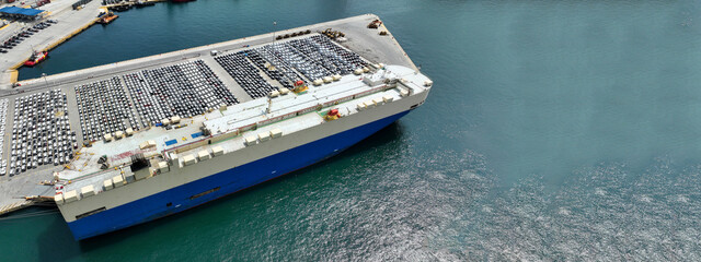 Aerial drone ultra wide photo with copy space of large car carrier ro ro vessel anchored in car...