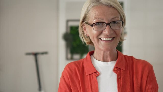 Portrait of one mature blonde caucasian woman with eyeglasses indoor