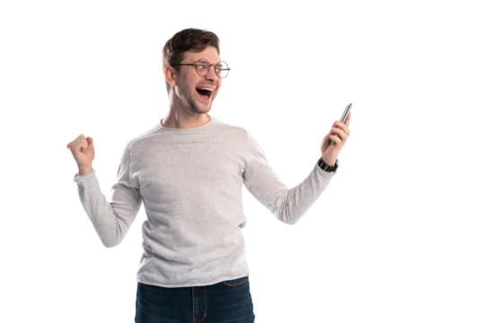 Happy man holding smartphone and celebrating his success over transparent background