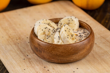 fresh banana-flavored yogurt with banana slices sprinkled with chia