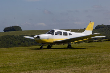 Fototapeta na wymiar Popular single engined private monoplane on the grass airfield.